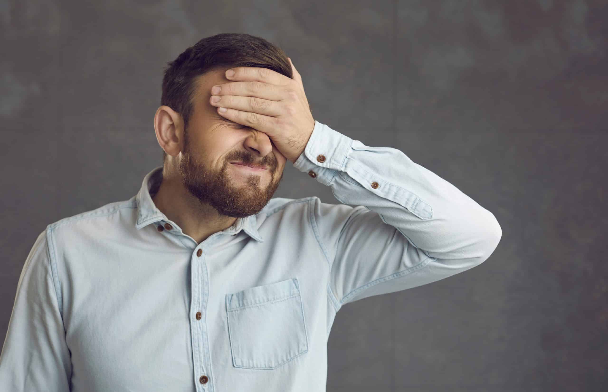 Businessman Covers Face With Hand. Guy Facepalms Feeling Ashamed Of