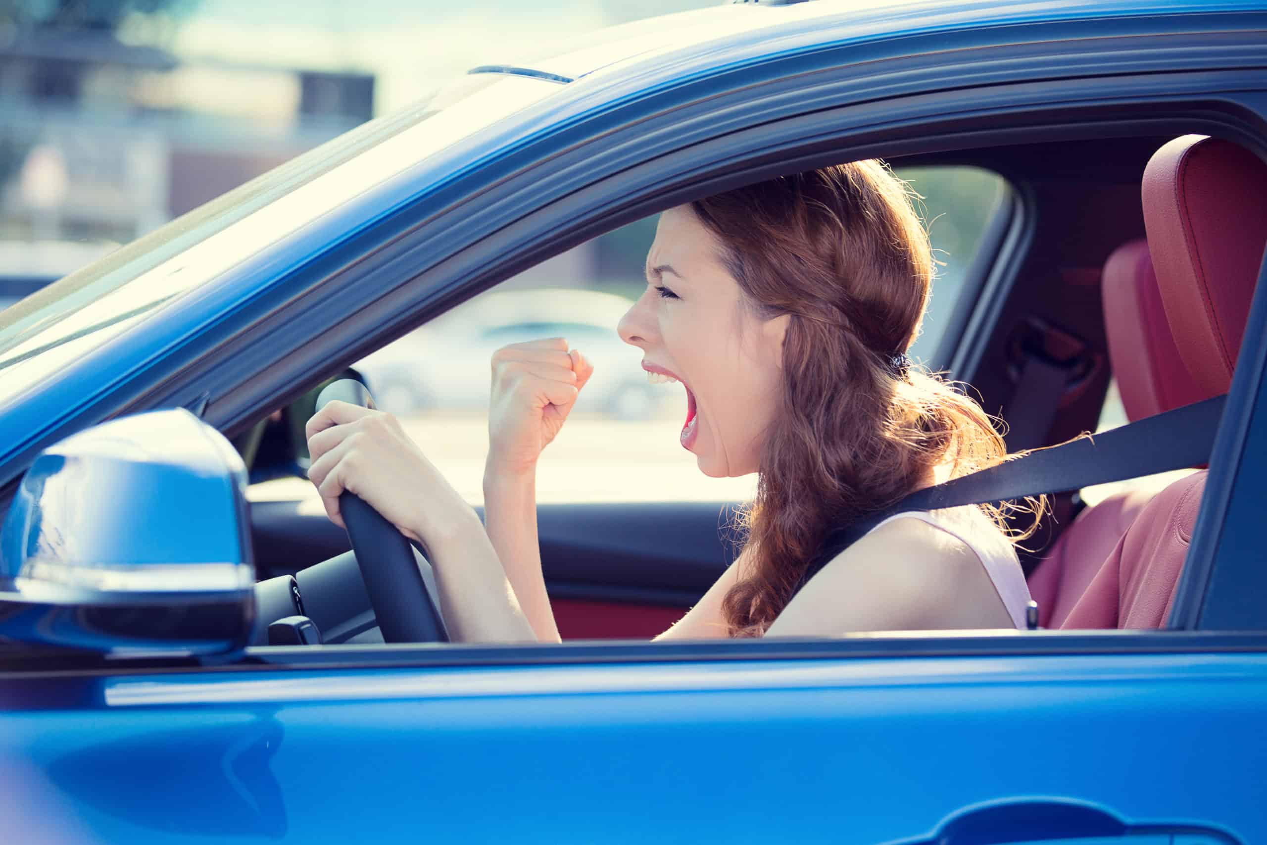 Closeup,portrait,displeased,angry,pissed,off,aggressive,woman,driving,car