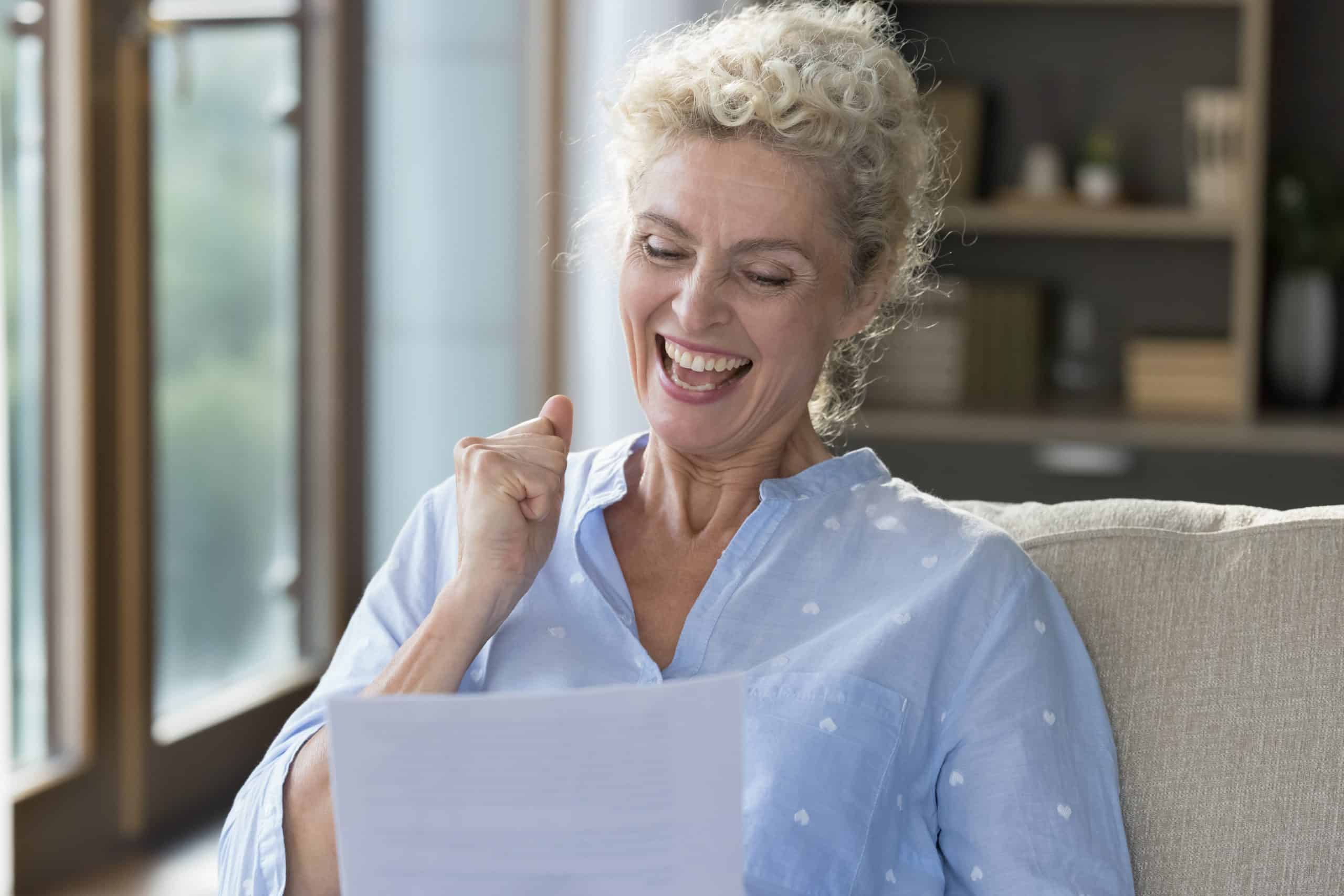 Cheerful Happy Mature Woman Reading Paper Letter Holding Legal Document