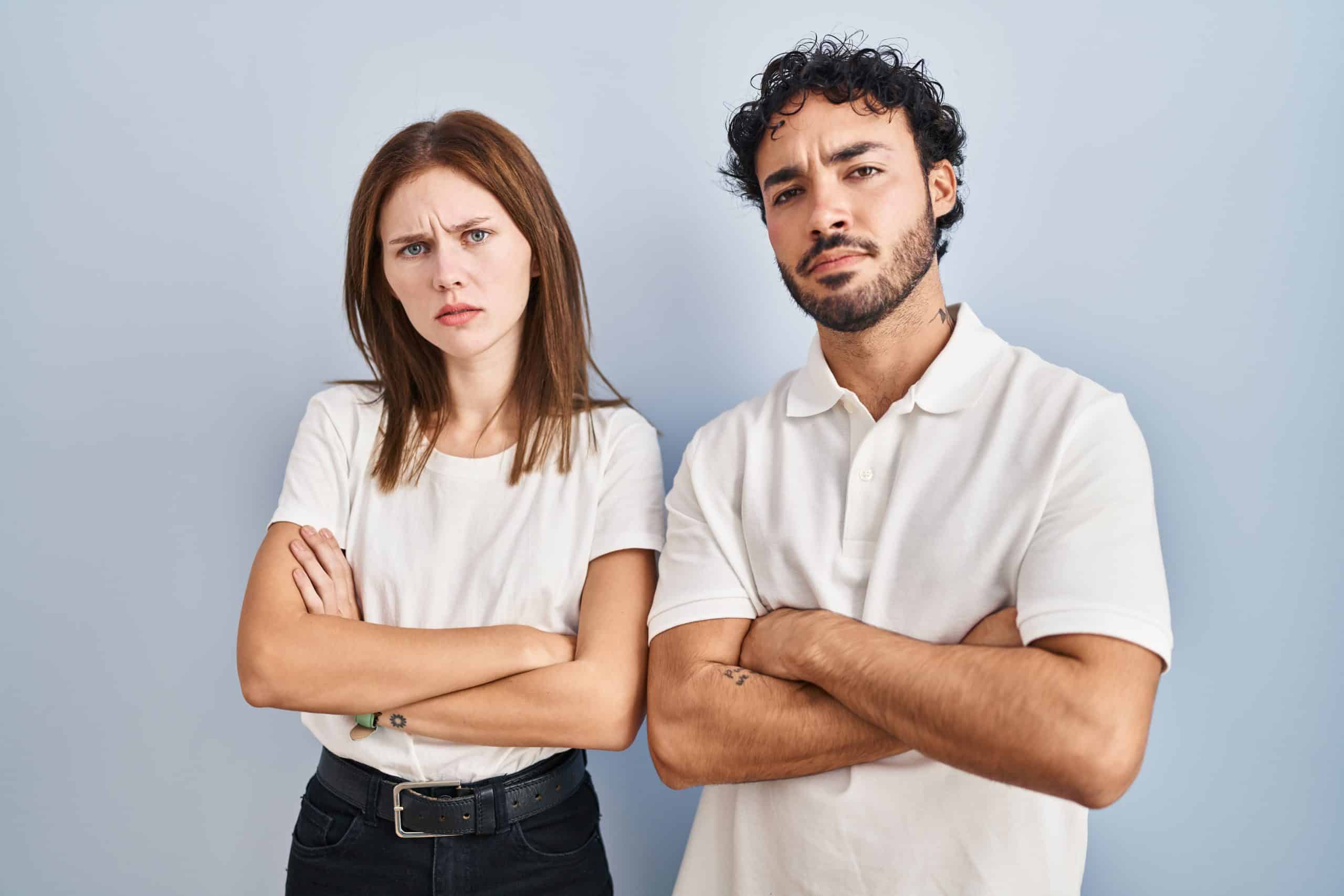 Young Couple Wearing Casual Clothes Standing Together Skeptic And Nervous